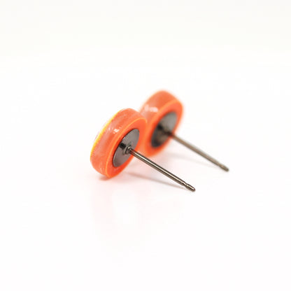 orange earrings on titanium posts