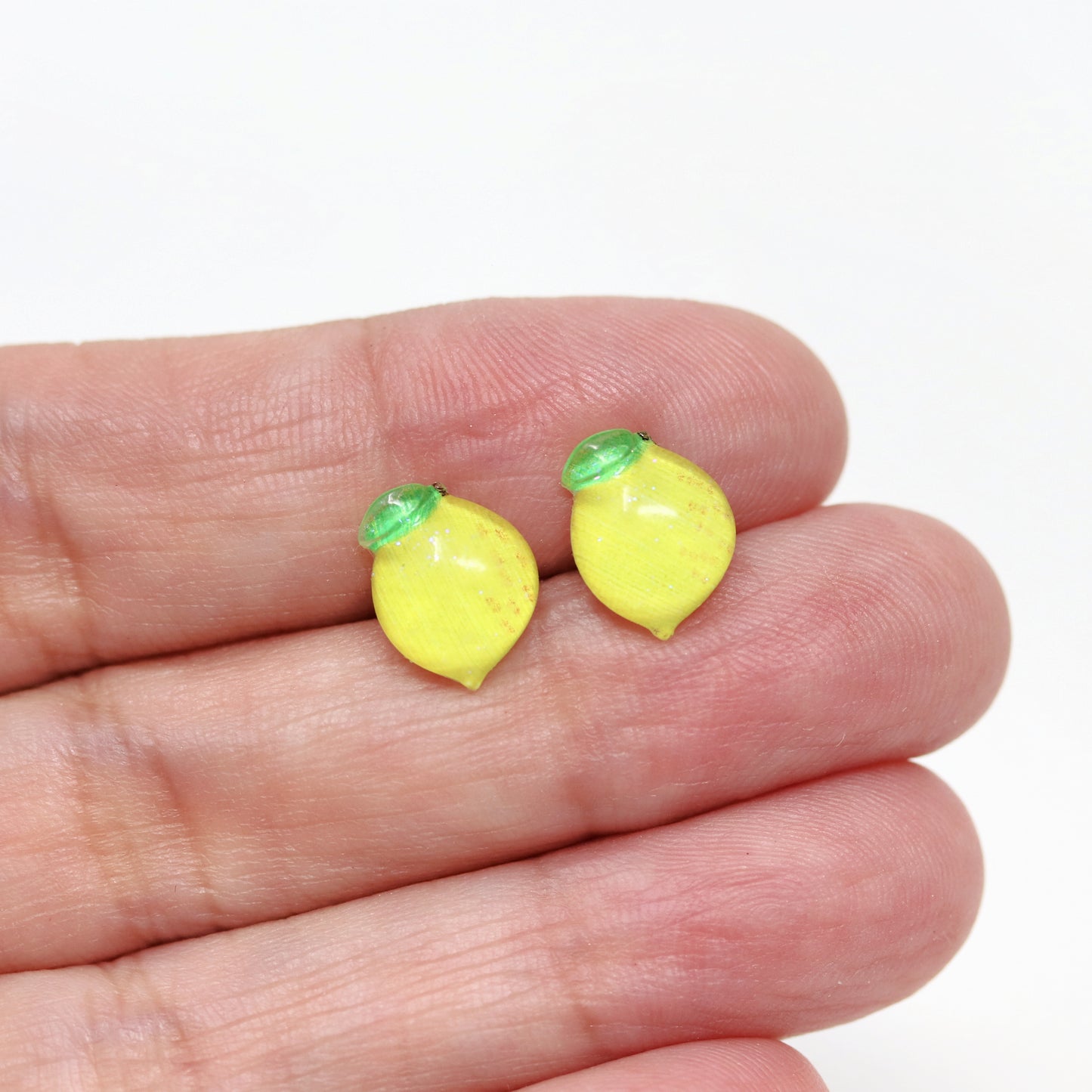 lemon earrings in a hand
