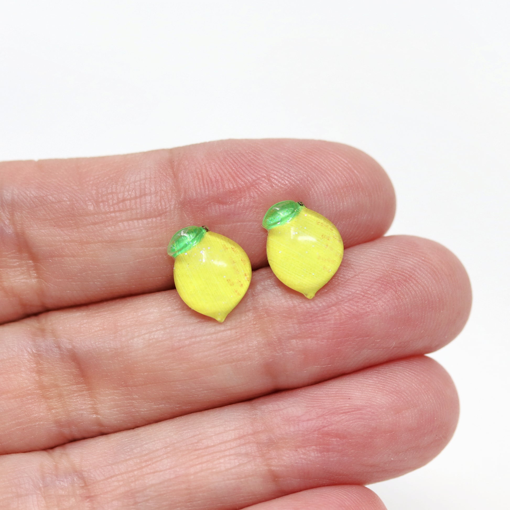 lemon earrings in a hand