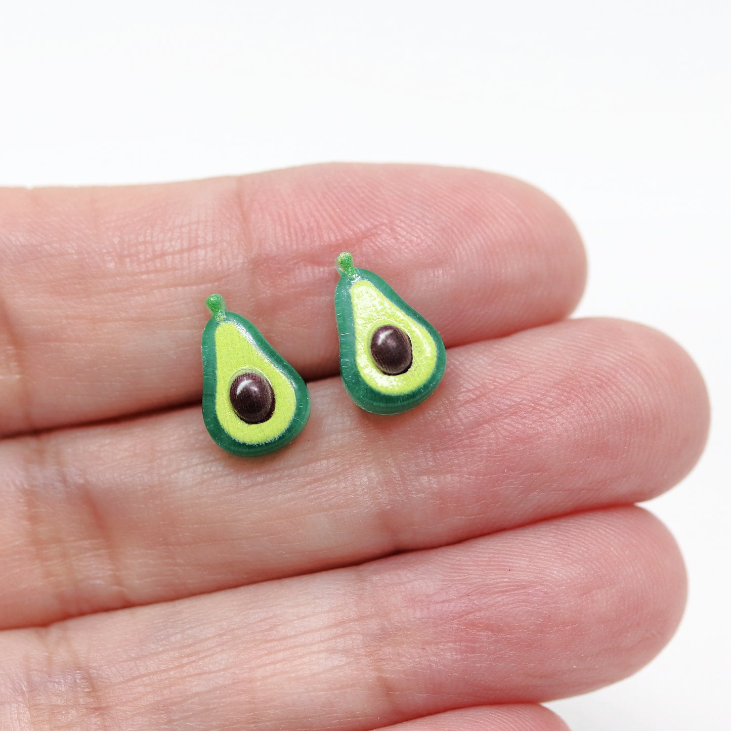avocado earrings in a hand
