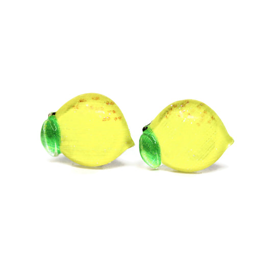 A pair of yellow lemon slice stud earrings with green details, crafted from resin, displayed on a white background.