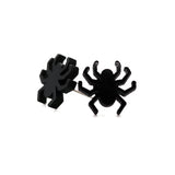Black spider-shaped earrings on a white background