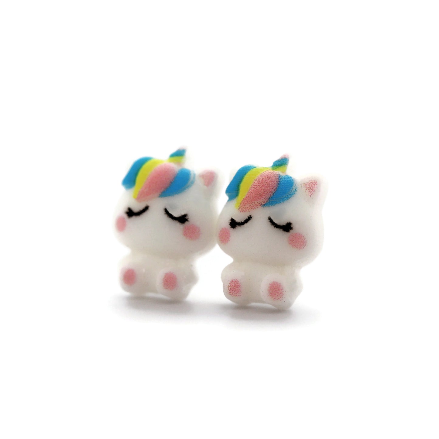 A pair of white unicorn stud earrings with rainbow-colored manes, crafted from resin, displayed against a white background.