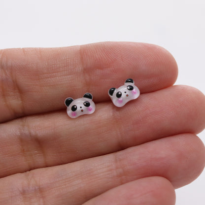 panda earrings in a hand
