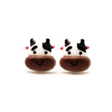 Pair of cow-shaped earrings with cartoon faces on a white background