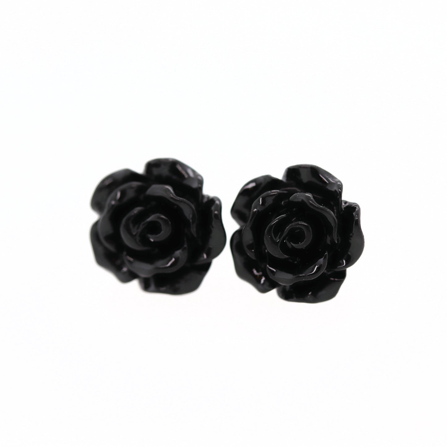 A pair of black rose flower earrings made of resin, displayed against a white background.