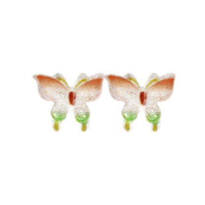 Two butterfly-shaped earrings on a white background