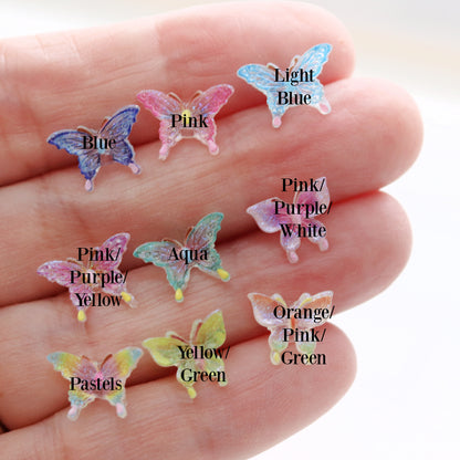 Colorful butterfly-shaped objects on a hand with labeled colors.