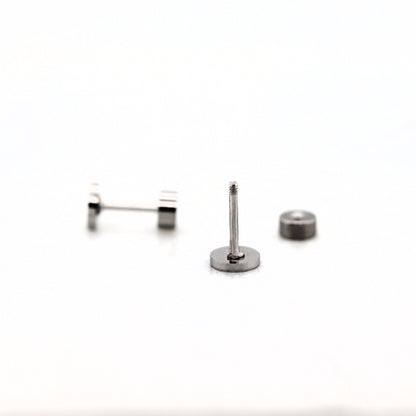 A stainless steel flat screw back earring post with a threaded post, accompanied by two small flat pads for attachment.