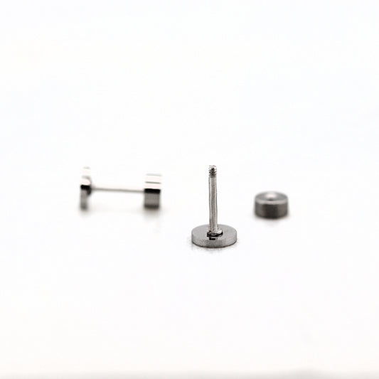 A stainless steel flat screw back earring post with a threaded post, accompanied by two small flat pads for attachment.