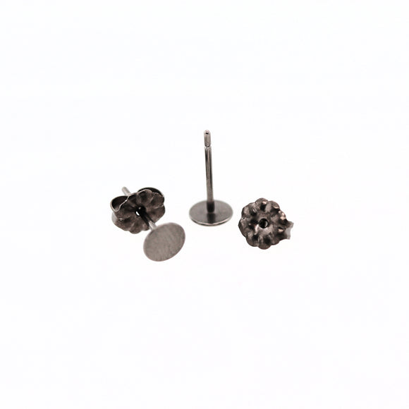 Pair of titanium earring posts with backs on a white background