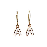 Gold earrings with white letter 'A' charms on a white background