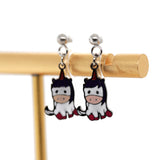 Unicorn-shaped earrings on a gold stand against a white background