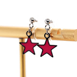 Pink star-shaped earrings on a gold stand against a white background