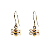 Bee-shaped earrings with gold and white design on a white background