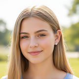 Close-up of an ear wearing a unicorn- stud earring with a blurred background