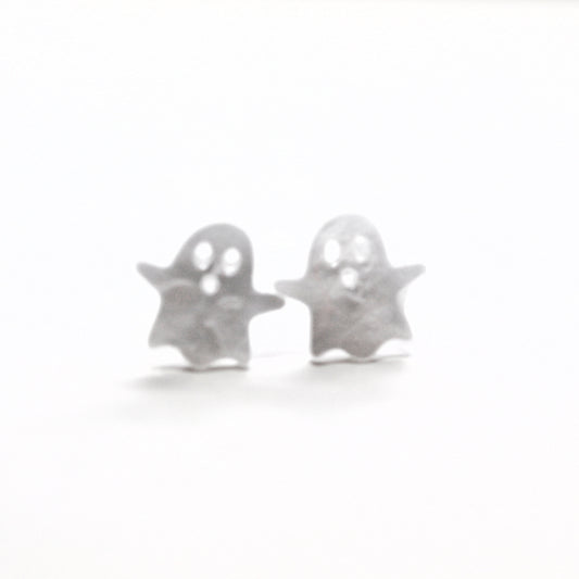 Silver ghost-shaped earrings on a white background