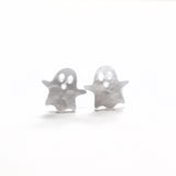 Silver ghost-shaped earrings on a white background