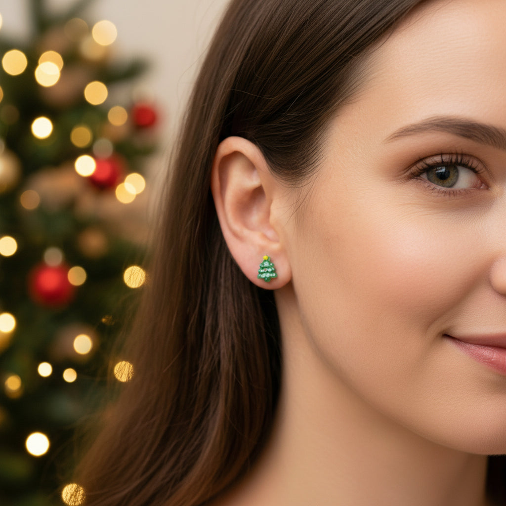 Person wearing festive earrings with a Christmas tree and lights in the background