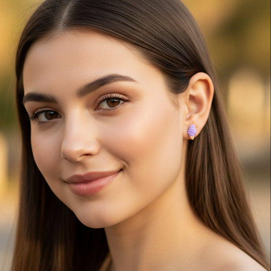 Close-up of a woman wearing earrings with a blurred outdoor background