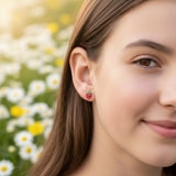 Close-up of an ear wearing a strawberry-shaped earring.