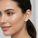 Close-up of an ear wearing a silver glitter ghost earring with a clear gemstone.