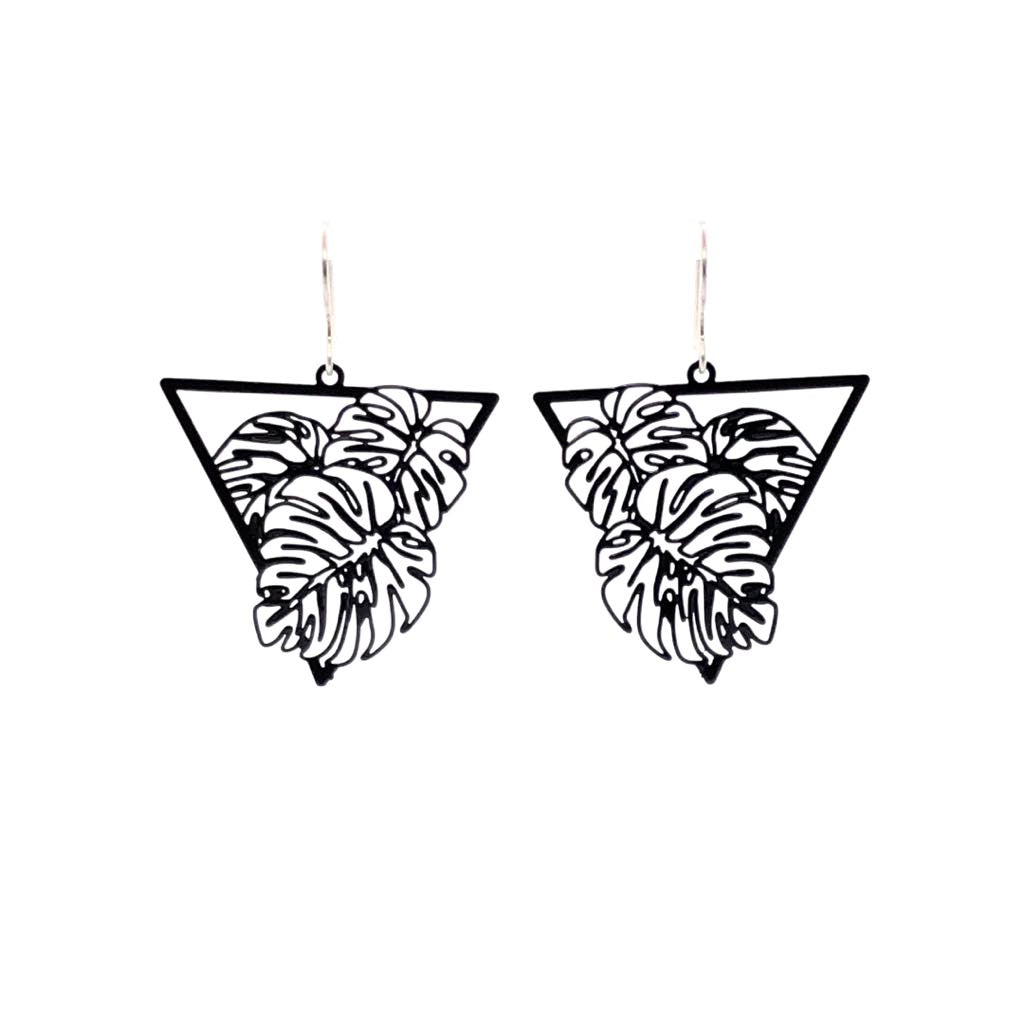 A pair of dangle earrings featuring a fine line monstera leaf design, with a black metal finish.