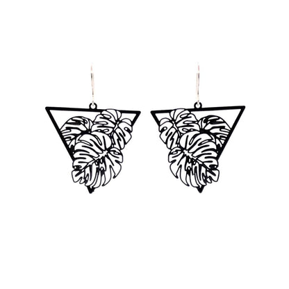A pair of dangle earrings featuring a fine line monstera leaf design, with a black metal finish.