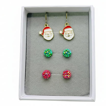 Set of Christmas-themed earrings including Santa face and colorful round designs in a box.