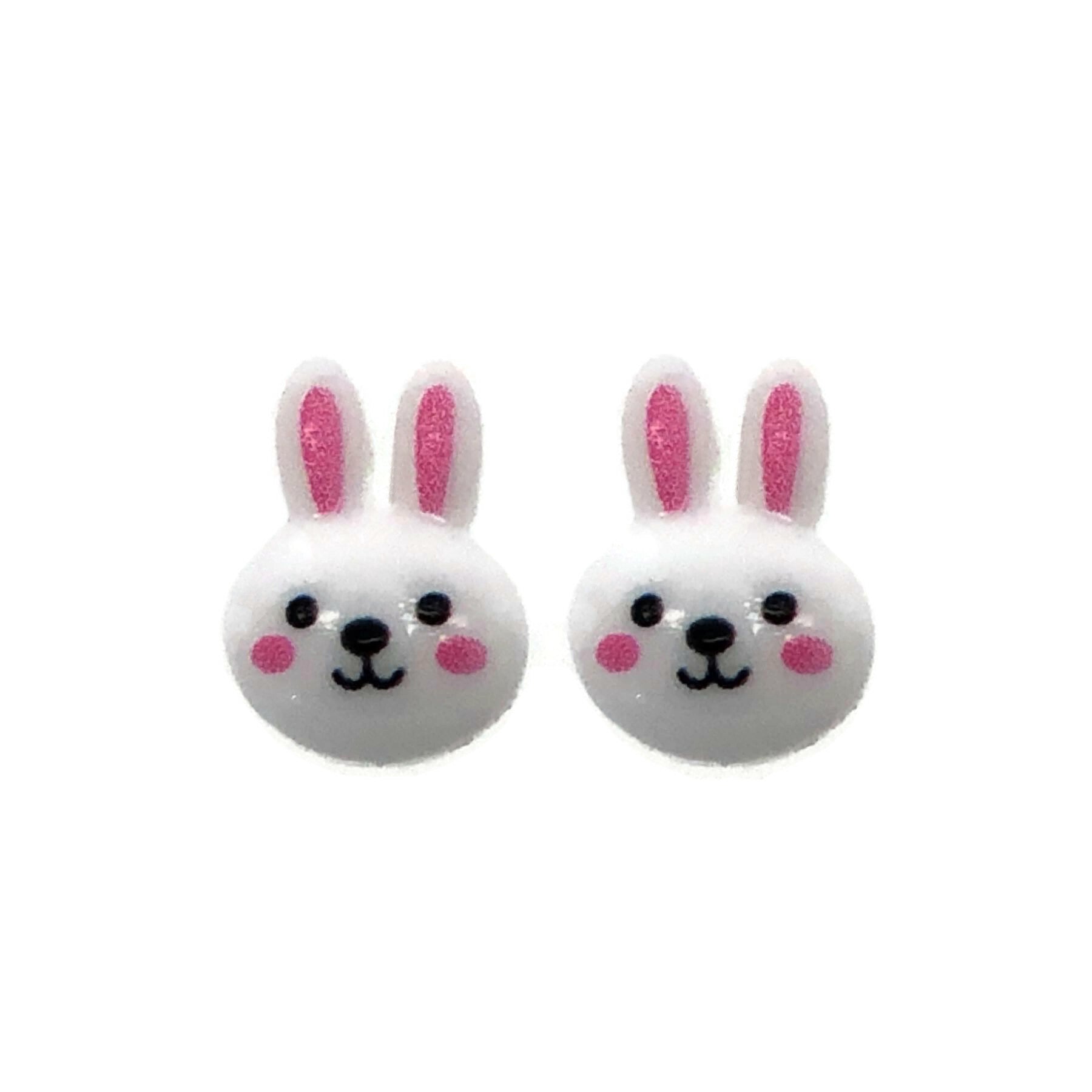 A pair of white bunny face stud earrings with pink inner ears and black eyes, attached to clear posts.