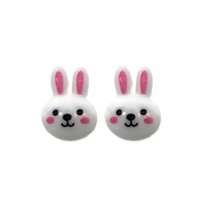 A pair of white bunny face stud earrings with pink inner ears and black eyes, attached to clear posts.