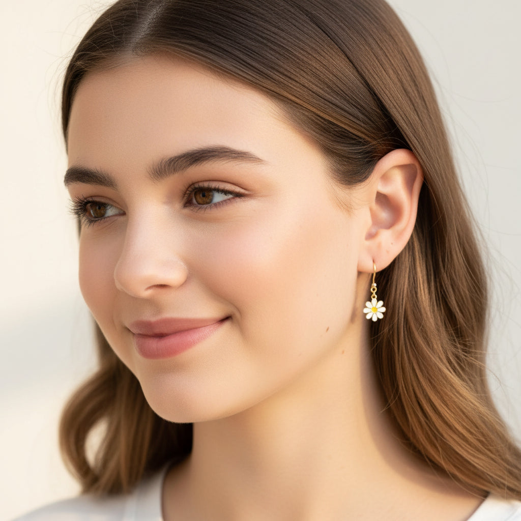 Close-up of an ear wearing a small dangle earring with a daisy charm.