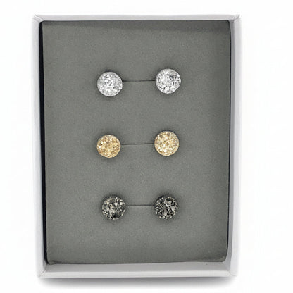 A set of three faux druzy stud earrings in varying colors displayed in a gift box.