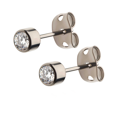 A pair of titanium stud earrings with bezel-set cubic zirconia stones.