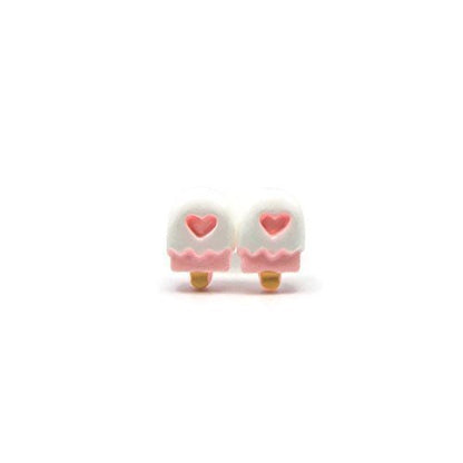 A pair of pink popsicle-shaped stud earrings with heart detail, attached to white posts.
