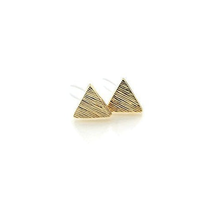 A pair of brushed gold triangle stud earrings.