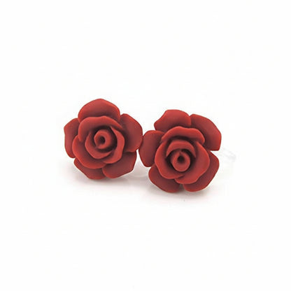 A pair of red rose stud earrings made of resin, displayed against a white background