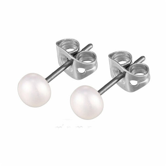 A pair of white freshwater pearl stud earrings attached to silver-colored titanium posts.