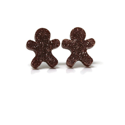 A pair of brown glitter acrylic gingerbread cookie shaped stud earrings.