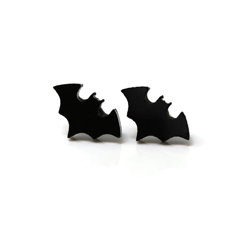 A pair of black bat-shaped stud earrings on a white background.