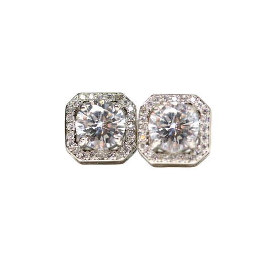A pair of silver-tone invisible clip-on earrings with a rhombus rhinestone halo design, featuring a clear glass round rhinestone in the center surrounded by smaller rhinestones.