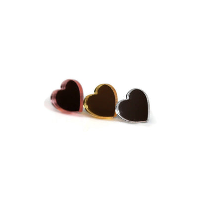 A set of three heart-shaped stud earrings in red, gold, and black colors, displayed against a white background.