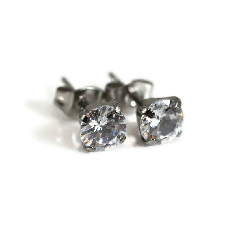 A pair of titanium 4-prong set cubic zirconia stud earrings.