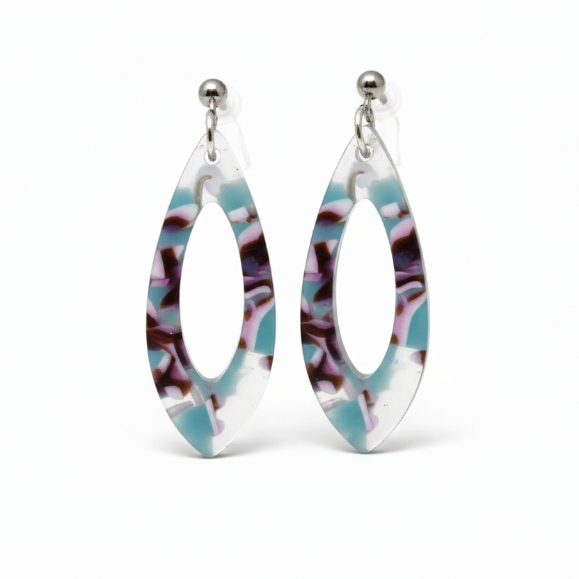 A pair of acrylic teardrop dangle earrings with a colorful pattern, displayed on a white surface with a floral background.