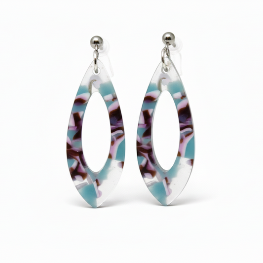 A pair of acrylic teardrop dangle earrings with a colorful pattern, displayed on a white surface with a floral background.