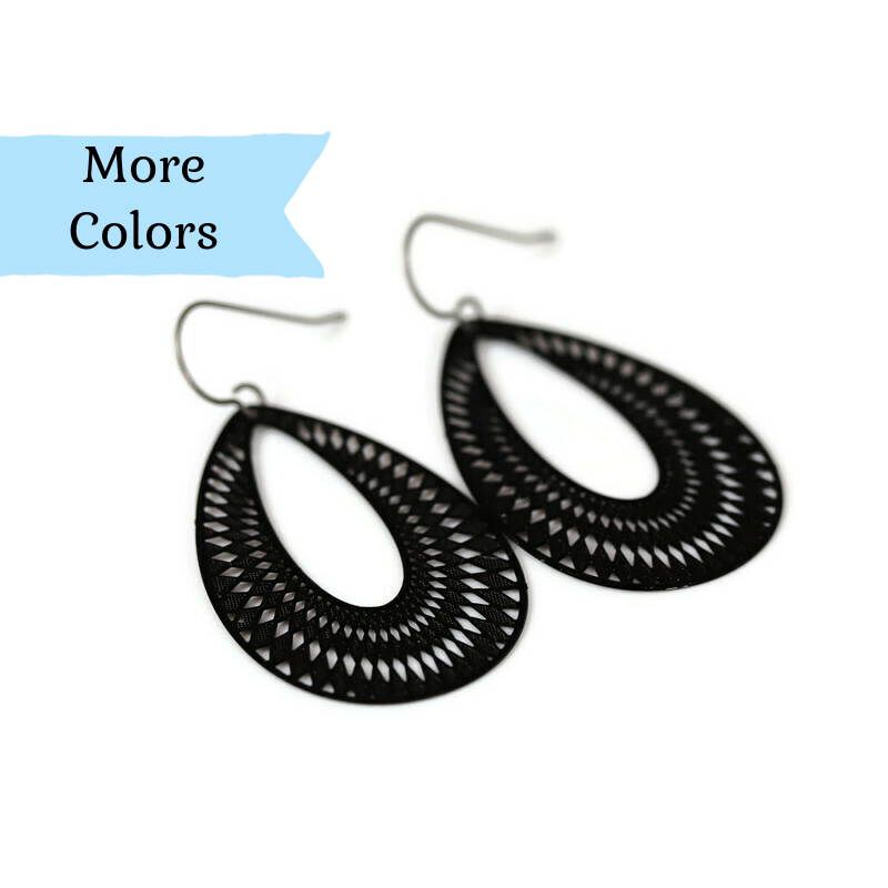 A pair of black, geometric teardrop dangle earrings with a plastic hook for non-pierced ears.