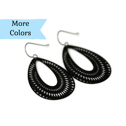 A pair of black, geometric teardrop dangle earrings with a plastic hook for non-pierced ears.