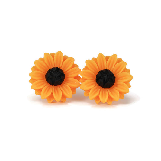 A pair of yellow sunflower stud earrings with black centers, crafted from resin, displayed against a white background.