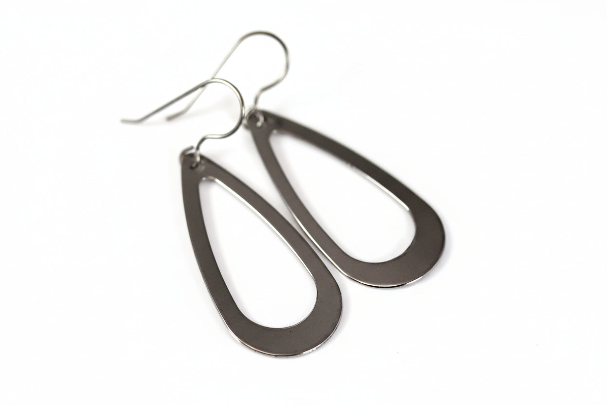 A pair of stainless steel teardrop dangle earrings with a visible hook.