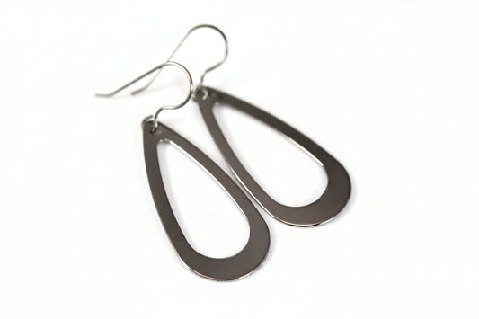 A pair of stainless steel teardrop dangle earrings with a visible hook.